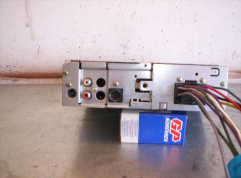 1995 Ford Bronco - The rear of a car stereo unit is shown, with various connectors and a bundle of wires.