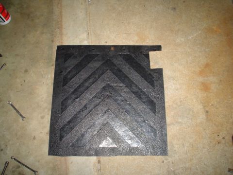 1967 Ford F-250 - Rubber mud flap with a chevron pattern, likely for a truck, on a concrete surface.