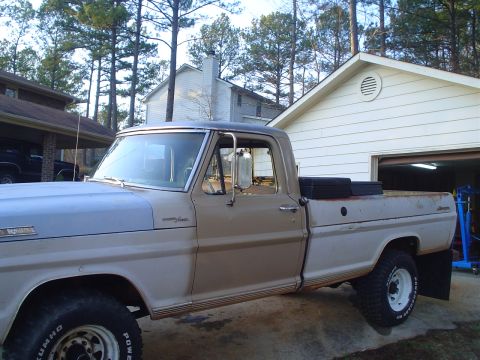 1967 Ford F-250 - A vintage Ford F-250 pickup truck is parked in a driveway next to a garage.
