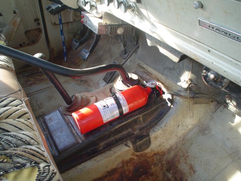 1967 Ford F-250 - Interior view of a 1967 Ford F-250, showing the floor, dashboard, and a mounted fire extinguisher.