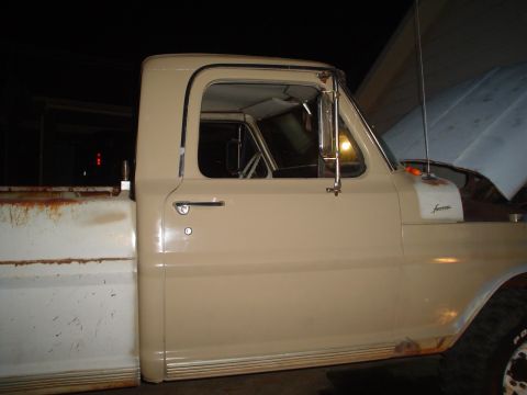 1967 Ford F-250 - Side view of a 1967 Ford F-250 truck, showing the cab door and fender.