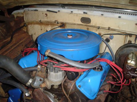 1967 Ford F-250 - Close-up of an engine bay with a blue air cleaner assembly and associated engine components.