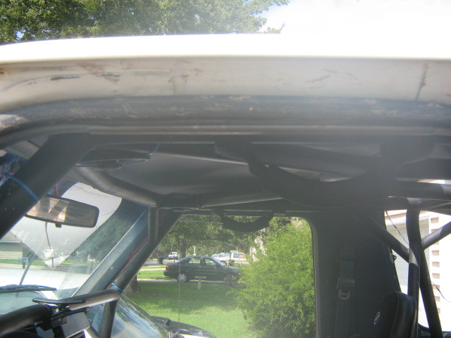 Blue Ford truck rear quarter with fender removed exposing bare metal and rust