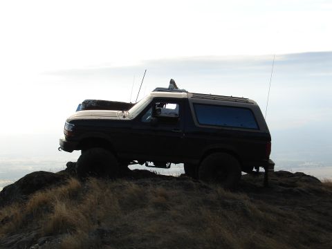 1996 Ford Bronco - This 1996 Ford Bronco is positioned on a rocky outcrop, offering a commanding view of the landscape below.
