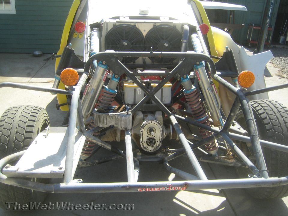Rear view of an off-road buggy chassis with twin coilover shocks and dual cooling fans