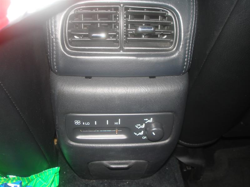 Black rear center console with air vents and rear climate fan and temperature controls