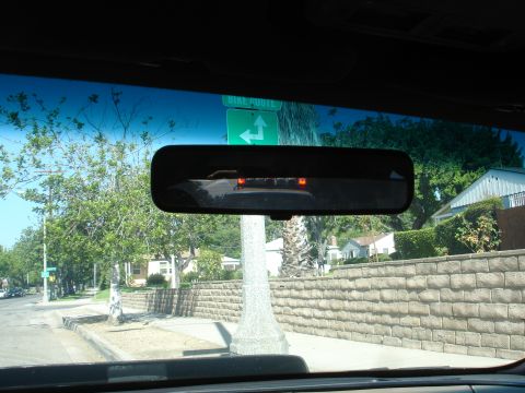 1993 Ford Taurus - View from inside a vehicle looking out at a street with a bike route sign and houses.
