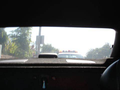 1993 Ford Taurus - Police car seen from inside another vehicle, with its emergency lights active.