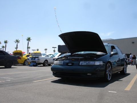 1993 Ford Taurus - A 1993 Ford Taurus is displayed with its hood open at an outdoor car show.