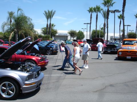 1993 Ford Taurus - Outdoor car show event with multiple vehicles on display and attendees.