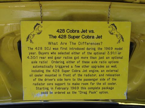 1992 Ford Taurus - A yellow sign explains the differences between two Ford engine models, referencing 1969.