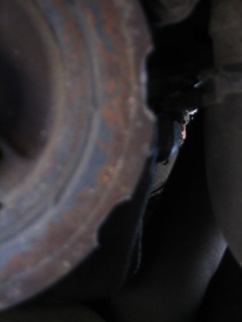 1993 Ford Taurus - This image shows a close-up view of a damaged engine pulley, possibly a crankshaft pulley.