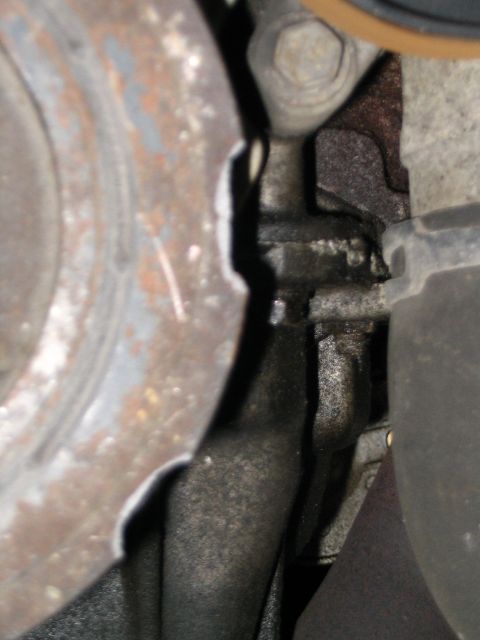 1993 Ford Taurus - A chipped pulley shows signs of wear and oil accumulation.