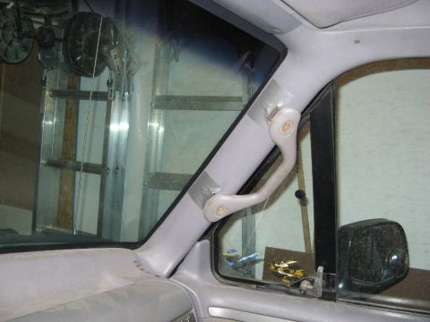 1995 Ford Bronco - The interior grab handle of a 1995 Ford Bronco, showing some wear and tear.