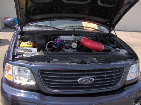 1991 Ford Taurus - The engine bay of a Ford F-150 truck is displayed with the hood open.