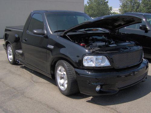 Black 1999 Ford F-150 SVT Lightning pickup truck, 3q front view, hood open
