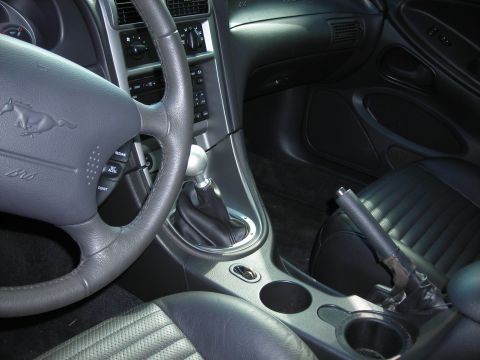 2003 Ford Mustang - Interior view of a 2003 Ford Mustang, highlighting the steering wheel and gear shifter.