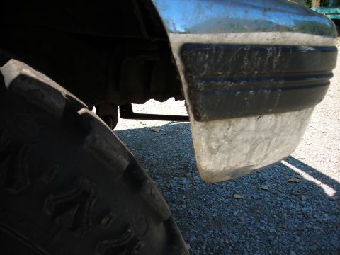 1994 Ford Bronco - Close-up view of the front fender and tire of a 1994 Ford Bronco.