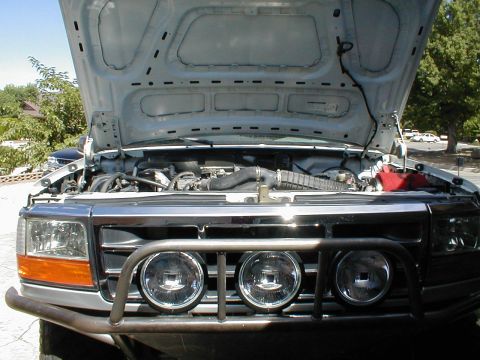1996 Ford Bronco - Front view of a 1996 Ford Bronco with the hood open, revealing the engine bay.