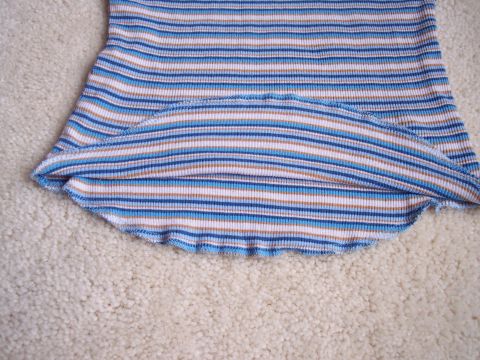 1968 Chrysler Town & Country - Close-up of a striped fabric with a ruffled hem, resting on a carpeted surface.