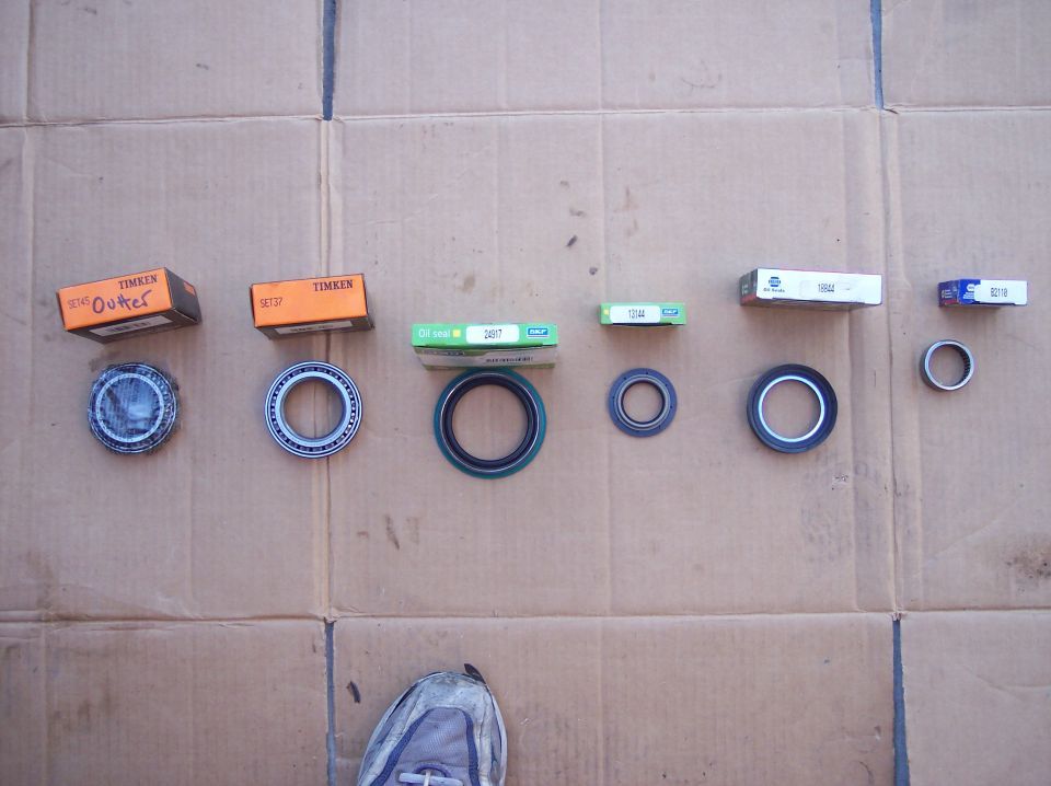 Row of Timken, SKF and Napa wheel bearings and oil seals on cardboard