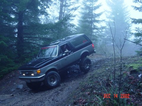 1989 Ford Bronco - This 1989 Ford Bronco navigates a challenging off-road trail on a foggy day.
