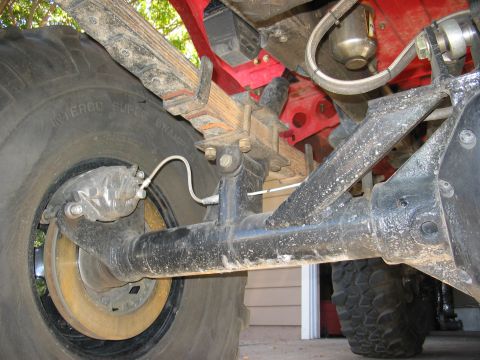 1970 Ford Bronco - This image shows the rear axle, brake assembly, and large tire of a vehicle, likely an off-road or modified truck.