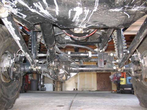 1970 Ford Bronco - Undercarriage view shows heavy-duty suspension and drivetrain of a modified off-road vehicle.