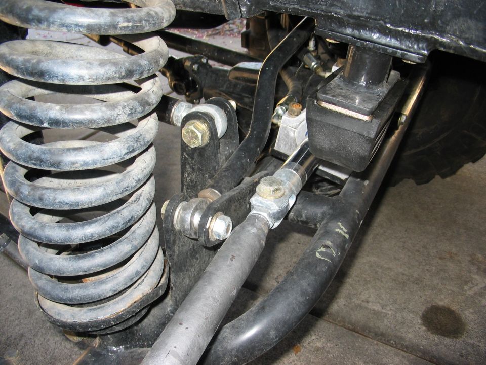 Close-up of suspension components with a SuperMotors.net watermark
