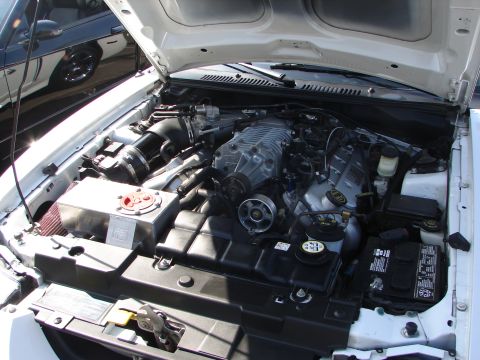 1992 Ford Taurus - Close-up of a modified engine bay a supercharger and custom components.
