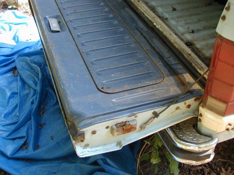 1986 Ford Bronco - Close-up of a vehicle's rear tailgate, showing its textured surface and latching hardware.
