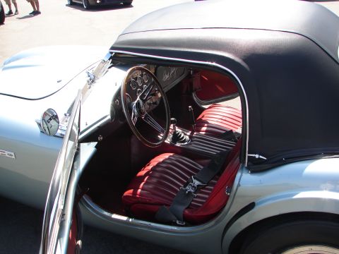1992 Ford Taurus - Interior view of a classic convertible sports car with red seats and a black soft top.