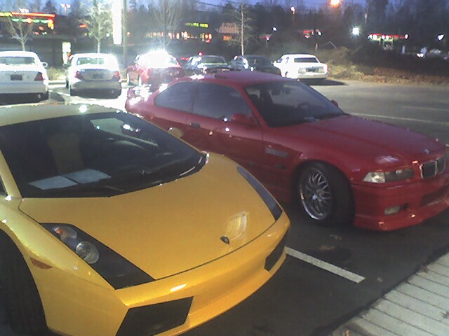 Yellow Lamborghini Gallardo parked next to a red BMW E36 coupe