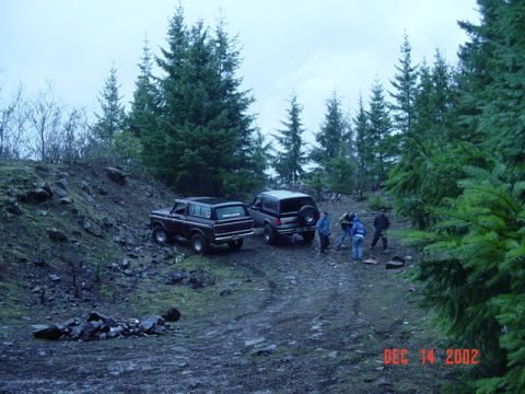 1989 Ford Bronco - Two Ford Broncos parked on a dirt road in a wooded area on December 14, 2002.
