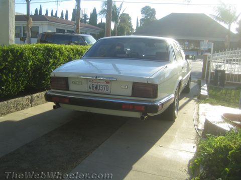 1968 Ford Mustang - This white Jaguar XJ6 sedan is parked in a driveway, showing its rear profile and California license plate.