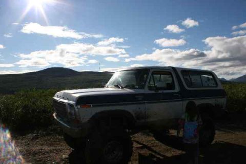1978 Ford Bronco - A 1978 Ford Bronco is parked in a scenic outdoor location under a bright sun.