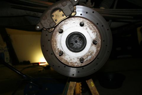 1978 Ford Bronco - Close-up of a vehicle's rear disc brake assembly, showing a rusty rotor and caliper.