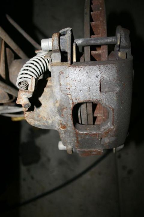 1978 Ford Bronco - Close-up view of a vehicle's rear disc brake caliper and rotor assembly.