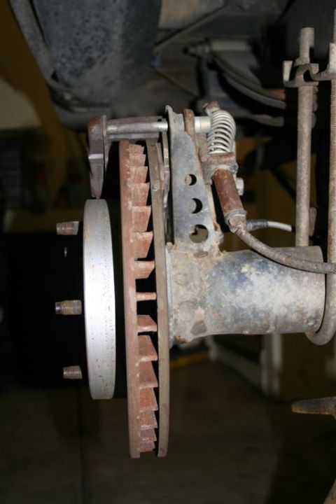 1978 Ford Bronco - Close-up of a vehicle's rear brake rotor and caliper assembly.