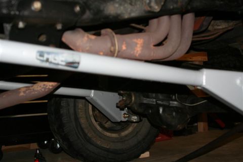 1978 Ford Bronco - Close-up of vehicle undercarriage, focusing on suspension and exhaust parts.