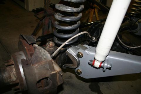 1978 Ford Bronco - Detail of a vehicle's suspension system, including brake components and shock absorber, with visible text from Supermotors.net.