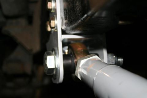 1978 Ford Bronco - Detail of a vehicle's suspension system, showing mechanical linkages and fasteners.