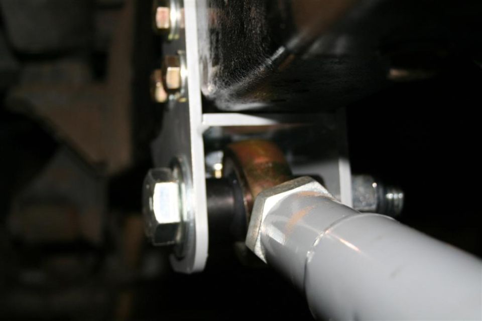 Close-up of a suspension component with bolts and a metal bracket