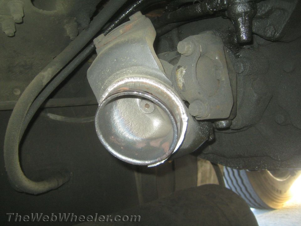 Close-up of a driveshaft U-joint yoke under a vehicle
