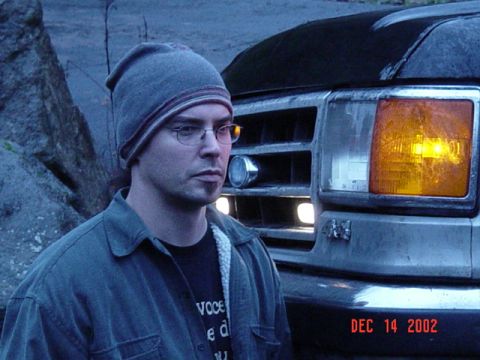 1989 Ford Bronco - A man stands next to the front of a truck, with a date stamp visible on the bumper.