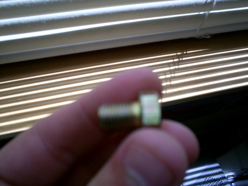 Bolt held by a finger in front of blinds