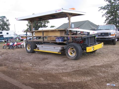 1998 GMC Sierra 1500 - Custom vehicle with a bar and canopy, parked outdoors with other vehicles nearby.