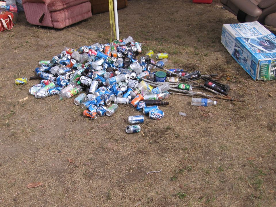 Large pile of empty beverage cans on the ground