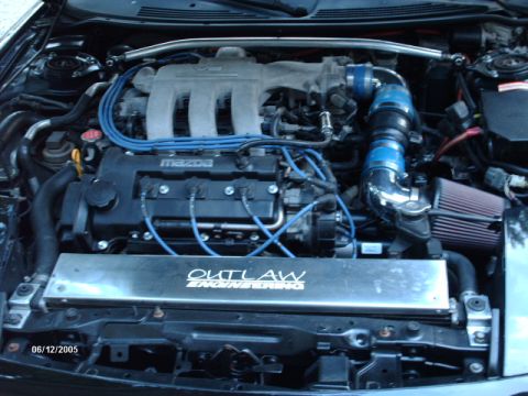 1995 Ford Probe - The engine bay of a vehicle is shown with custom modifications and visible "Mazda" branding.
