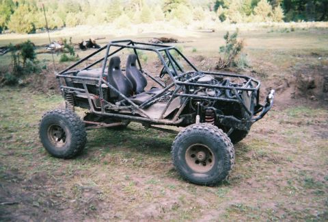 1984 Ford Bronco - This custom-built buggy features a prominent roll cage and exposed engine, ready for off-road use.